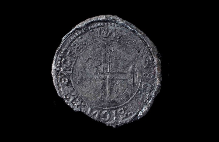 This undated photo made available by Blue Water Recoveries company on Tuesday, March 15, 2016 shows a rare silver coin called an Indio discovered from the debris of the explorer Vasco da Gama's ship, Esmeralda which sank in a storm in May 1503 off the coast of Al Hallaniyah island in Oman's Dhofar region. (Blue Water Recoveries company via AP)